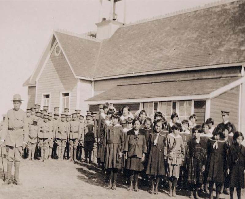 Group of people outside building at St. Pauls Blood school 
