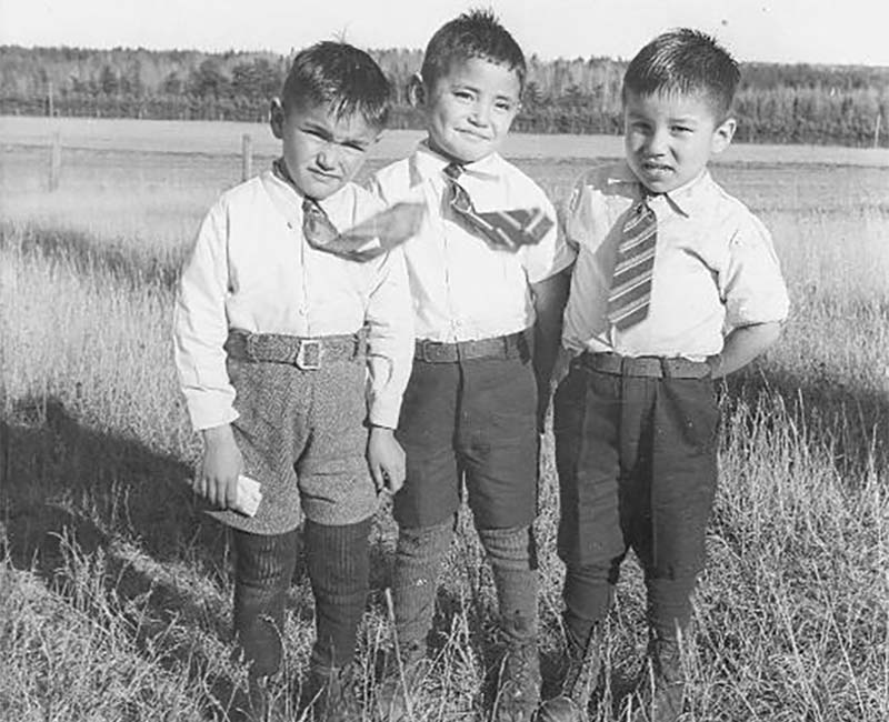 Three students standing outside from Chapleau St. John's school