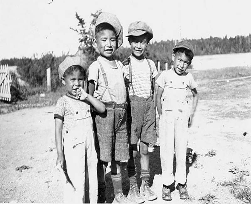 Four students standing outside at Pelican Lake school