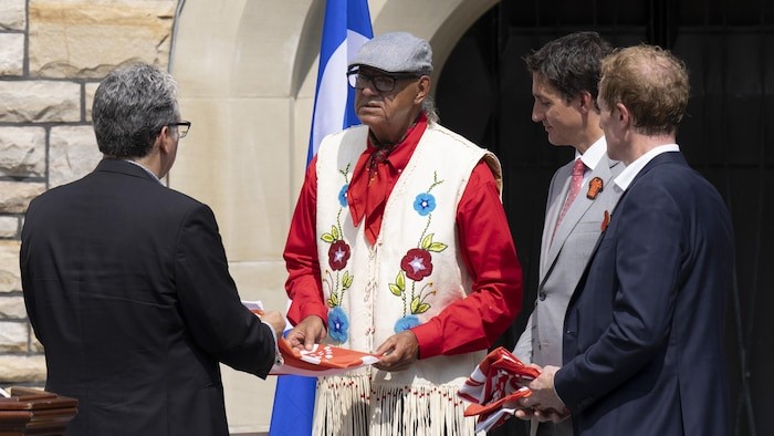 Eugene Arcand and Prime Minister Justin Trudeau at the Survivors flag ceremony in Ottawa.