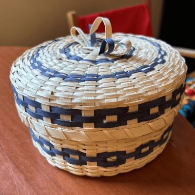 A woven basket, a gift presented by Elder Claudette Commanda from the McLean Day Schools Settlement Corporation to the NCTR.